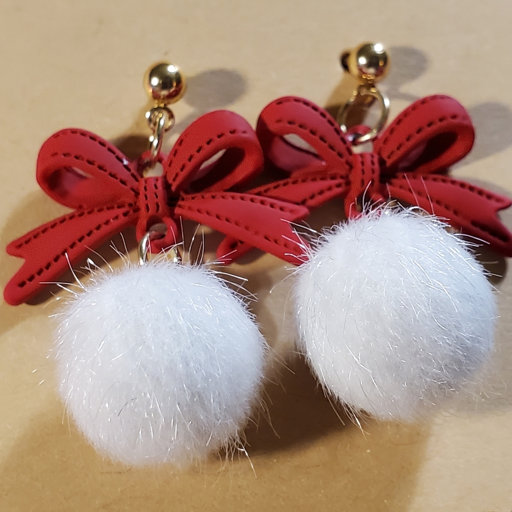 Fluffy white Snowballs hang from a little red bow in a gold setting. So Cute!!